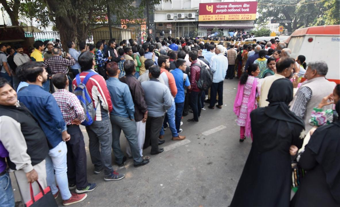 People standing in long queues to exchange their old Rs 500 and 1000 notes and withdraw cash from the ATM in New Delhi. Pic/PTI